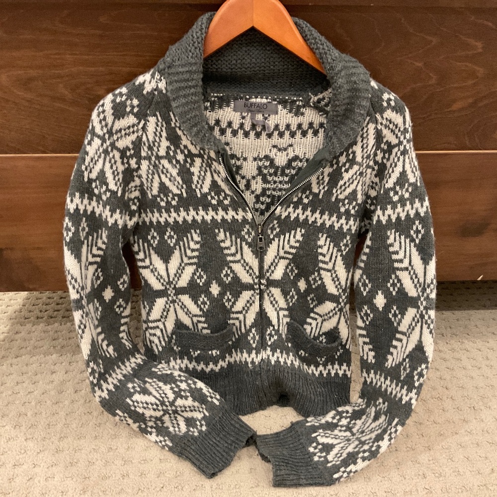 Zip up grey and white sweater.